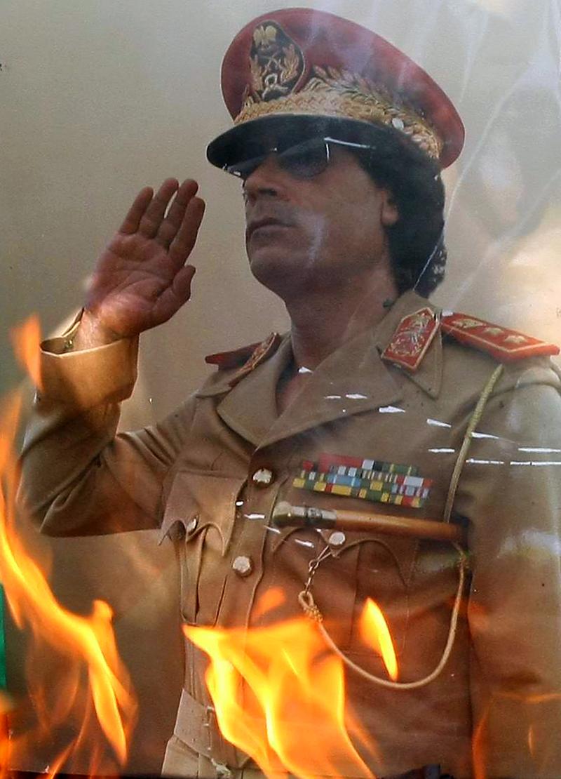 Close up of a portrait of Libyan leader Moammar Gadhafi set on fire by demonstrators during a protest outside the Libyan embassy in Ankara on August 22, 2011.